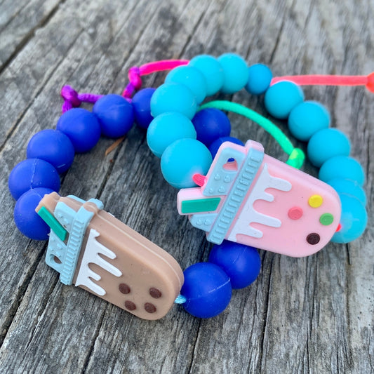 ChewBling Sensory Boba Chew Bracelets - Strawberry Boba Tea with turquoise blue silicone beads and Classic Milk Tea Boba with indigio blue beads. Adjustable length