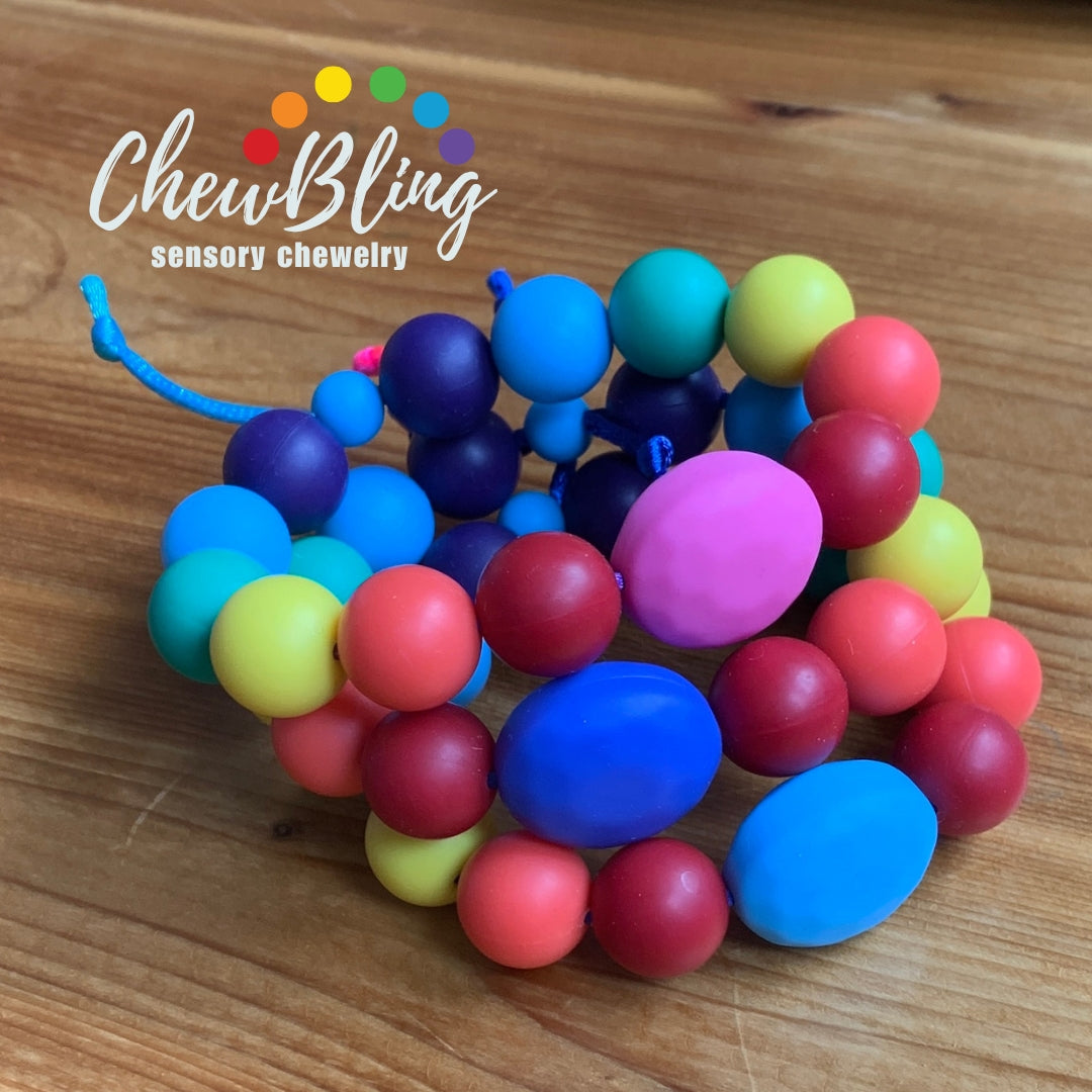 ChewBling Sensory PEBBLE Chew Bracelets are made kids who are sensory seekers. Adjustable in length with a spectrum of colored beads.