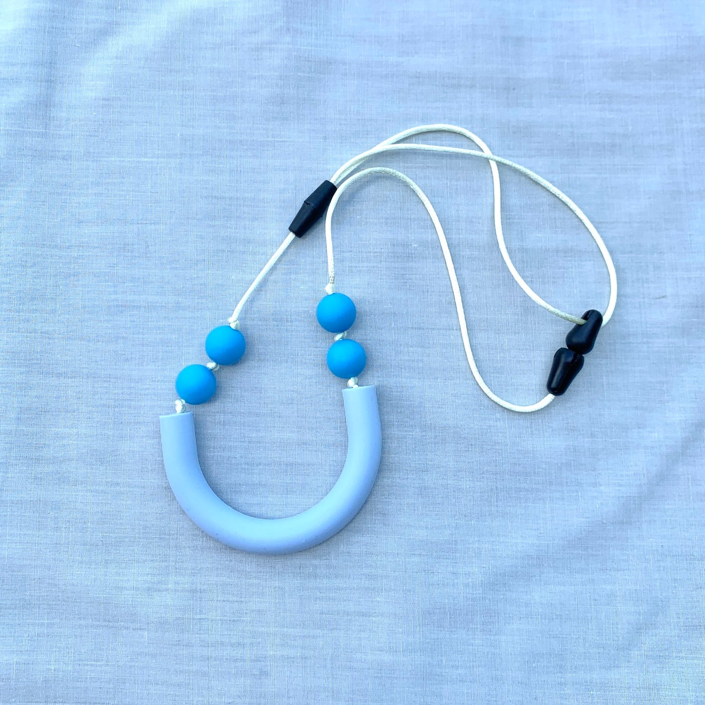 ChewBling Sensory Baby Blue curved TUBE chew necklace is designed for sensory seekers, autism, anxiety, ADHD and oral motor needs.