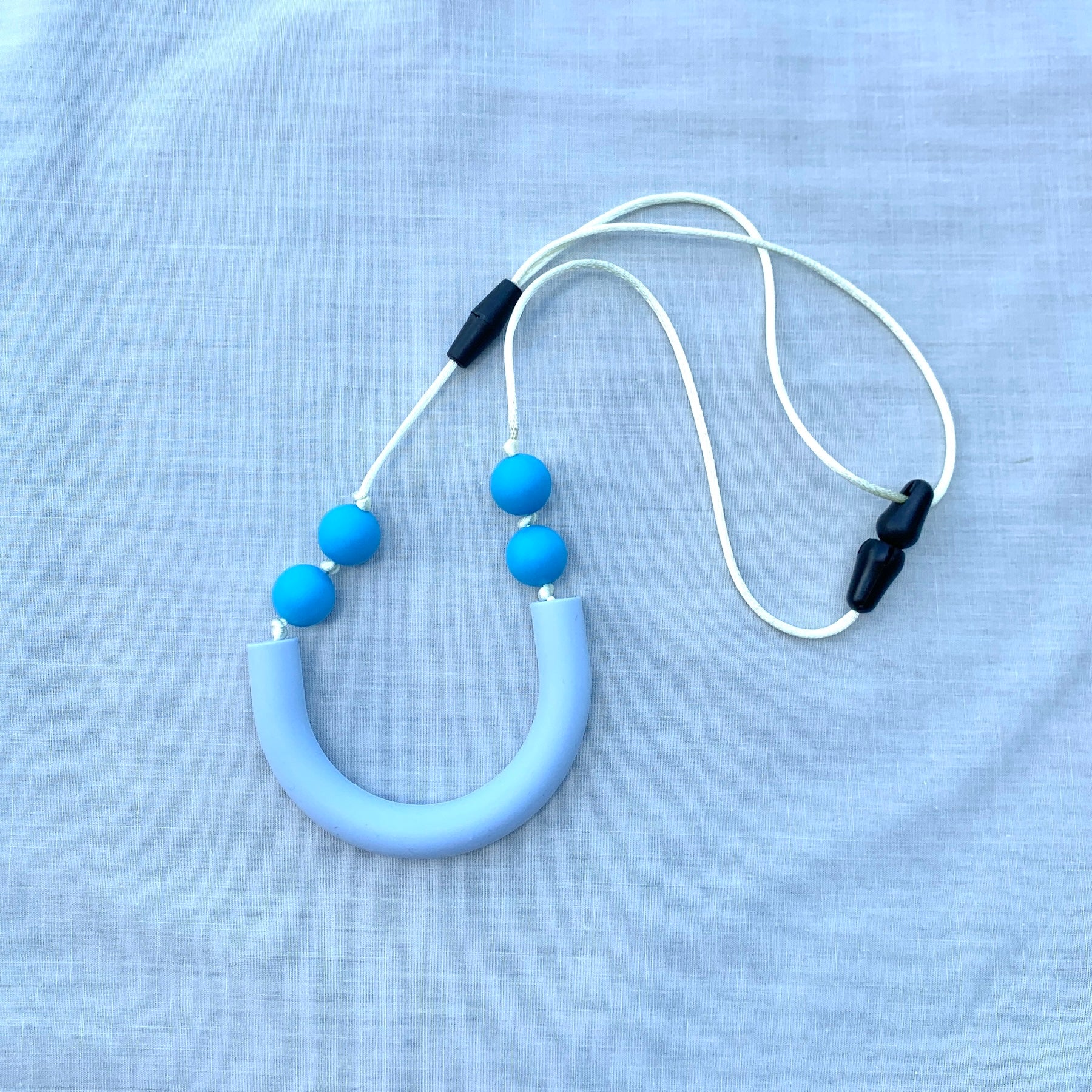 ChewBling Sensory Baby Blue curved TUBE chew necklace is designed for sensory seekers, autism, anxiety, ADHD and oral motor needs.