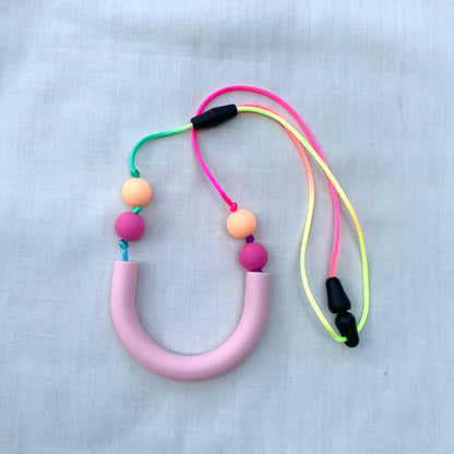 ChewBling Sensory Pastel Pink curved TUBE chew necklace is designed for sensory seekers, autism, anxiety, ADHD and oral motor needs.