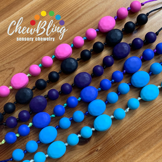 ChewBling Sensory PEBBLE Chew Necklace has two different shaped silicone beads to provide texture for sensory seekers. Designed with a safety breakaway clasp and adjustable necklace length.